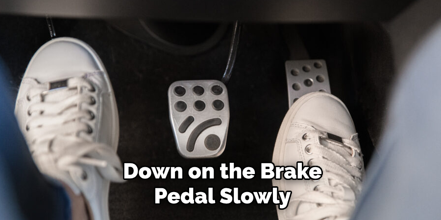 Down on the Brake Pedal Slowly