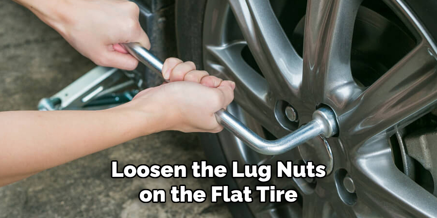 Loosen the Lug Nuts on the Flat Tire