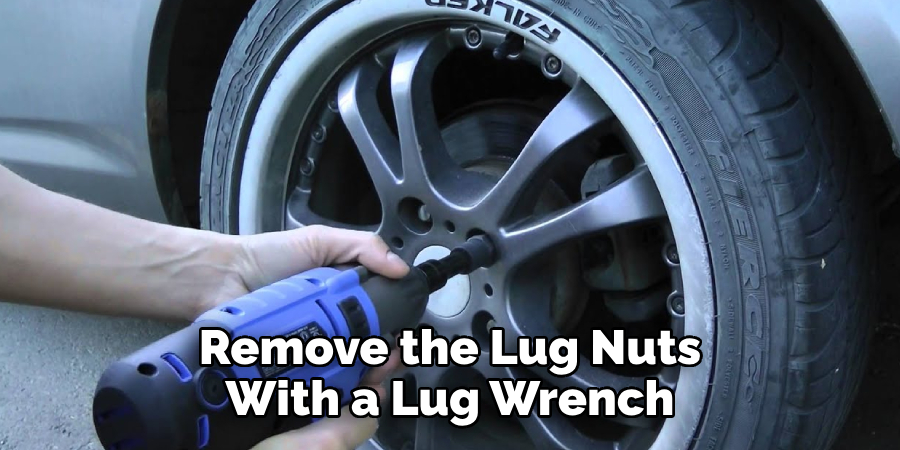 Remove the Lug Nuts With a Lug Wrench