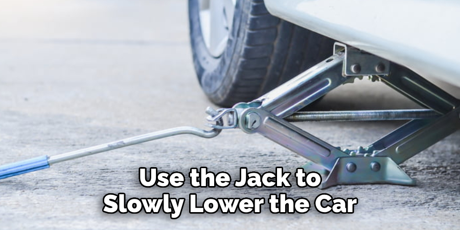 Use the Jack to Slowly Lower the Car