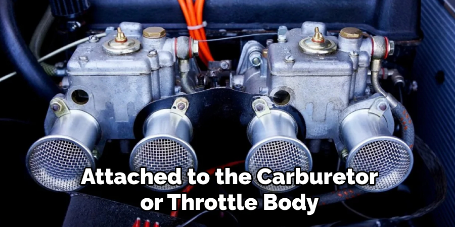 Attached to the Carburetor or Throttle Body
