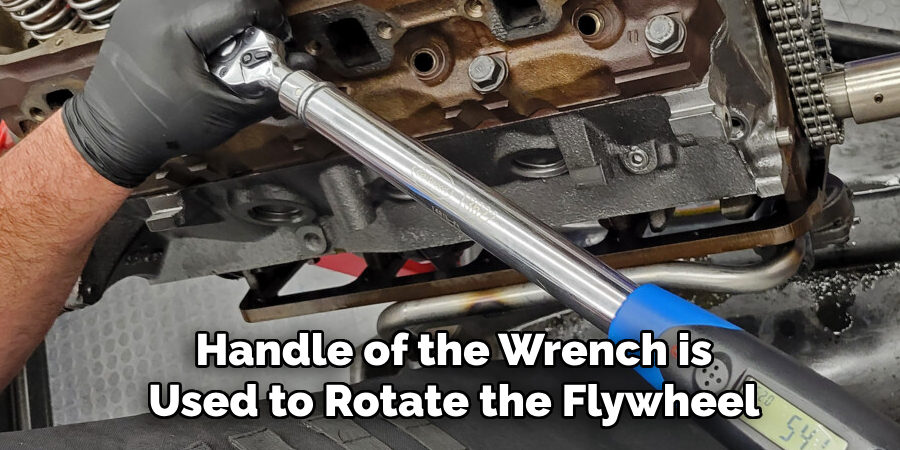 Handle of the Wrench is Used to Rotate the Flywheel