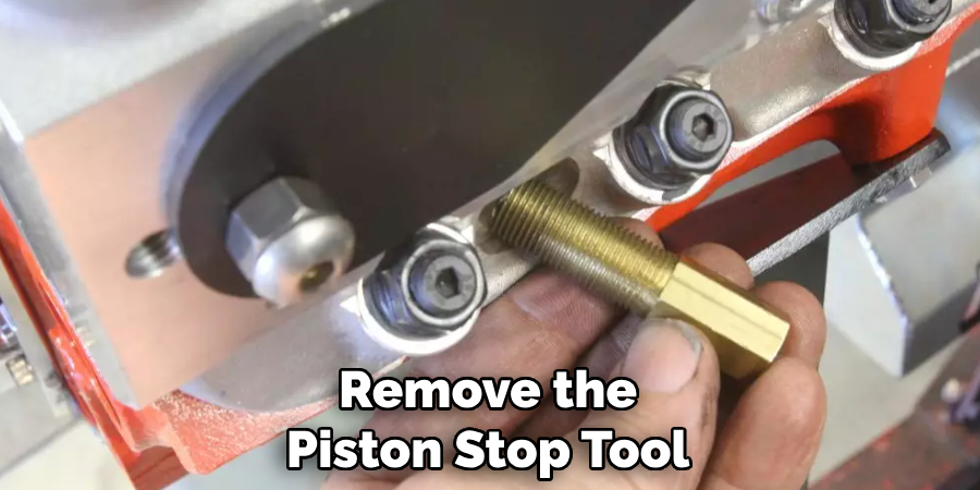 Remove the Piston Stop Tool