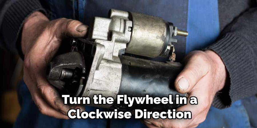 Turn the Flywheel in a Clockwise Direction